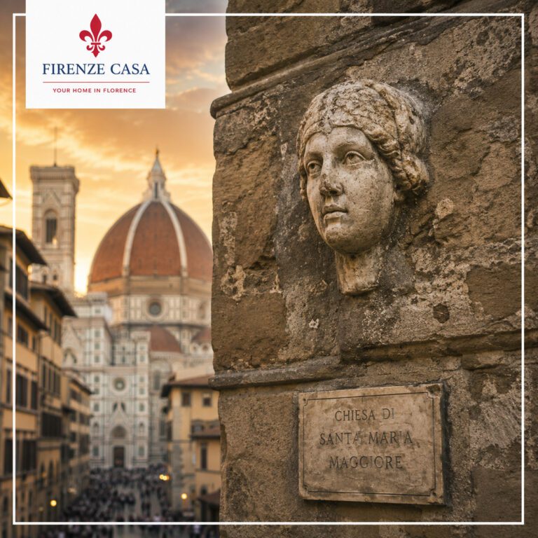 The Stone Head of Berta (La Testa di Berta) on the former bell tower of the Church of Santa Maria Maggiore (Chiesa di Santa Maria Maggiore) in Florence, with the Duomo in the background.