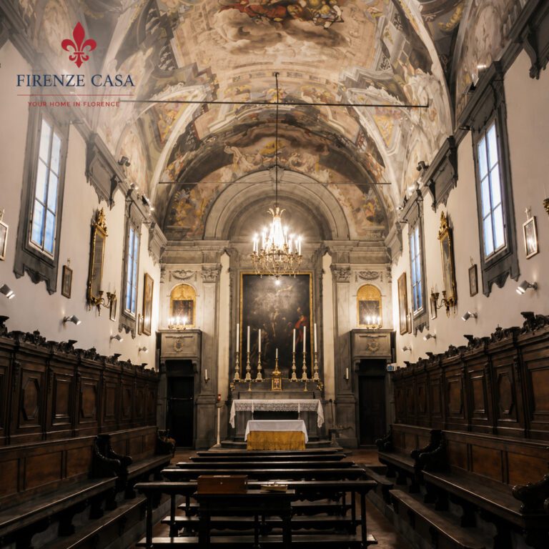 Interior of Oratorio del Ceppo in Florence with frescoed ceiling and historic wooden choir stalls