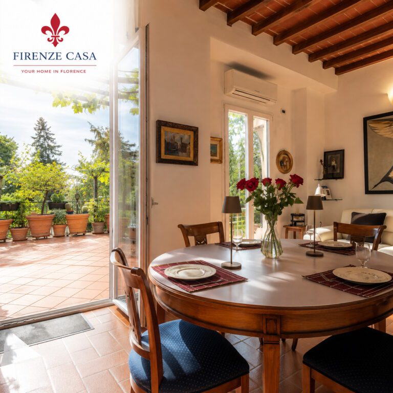 Bright dining and living area at FirenzeCasa with terrace access, illustrating the warm and personal atmosphere of a private home in Florence.